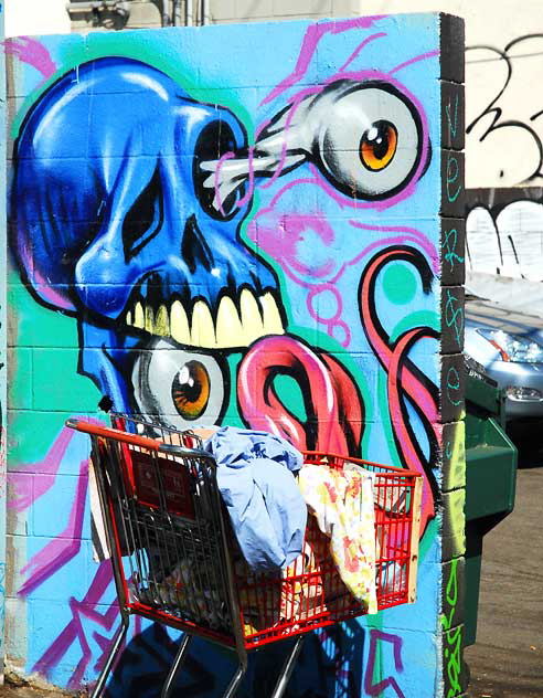 "Eye" graffiti and shopping cart in alley off Melrose Boulevard