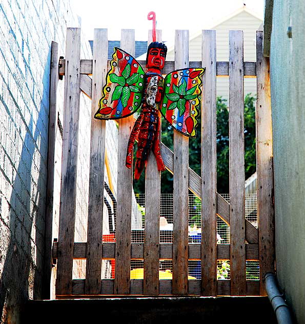 Butterfly Man on Wooden Fence - Sunset Junction 