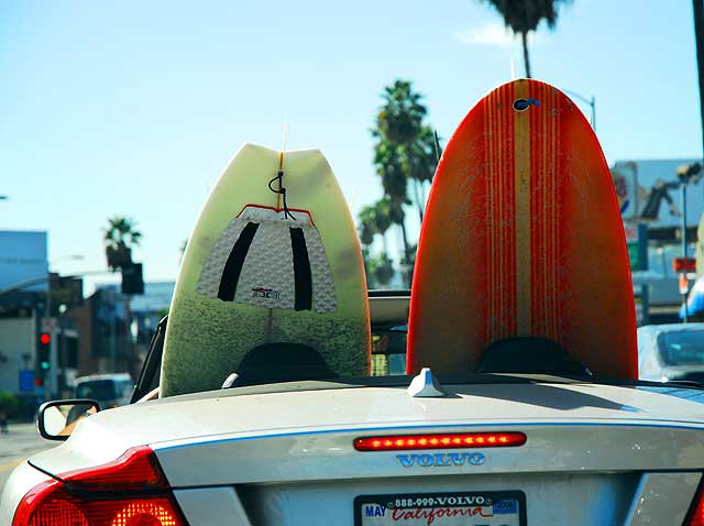 Surfboards in a convertible waiting for the light at Billy Wilder Square