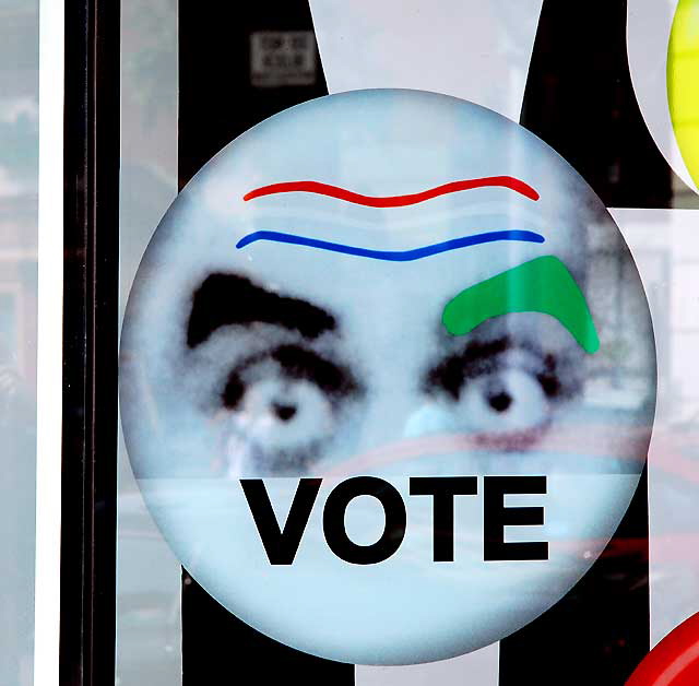 Vote button with big eyes - in the window of the Gap store at Hollywood and Highland, Hollywood Boulevard