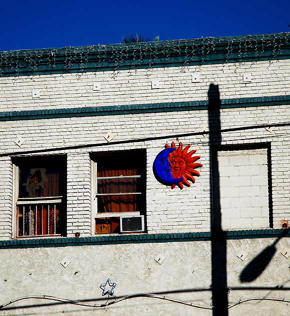 Moon-Sun plaque on brick wall, Sunset Boulevard at Vendome Street