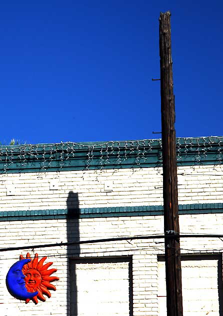 Moon-Sun plaque on brick wall, Sunset Boulevard at Vendome Street