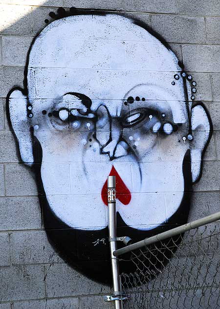 Graffiti face on concrete block wall - Hollywood Boulevard