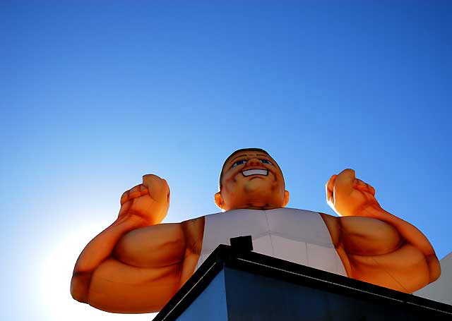 Inflatable muscle man, Sunset Boulevard near Gower