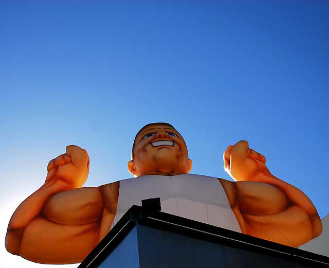 Inflatable muscle man, Sunset Boulevard near Gower