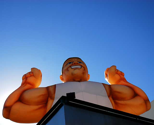 Inflatable muscle man, Sunset Boulevard near Gower