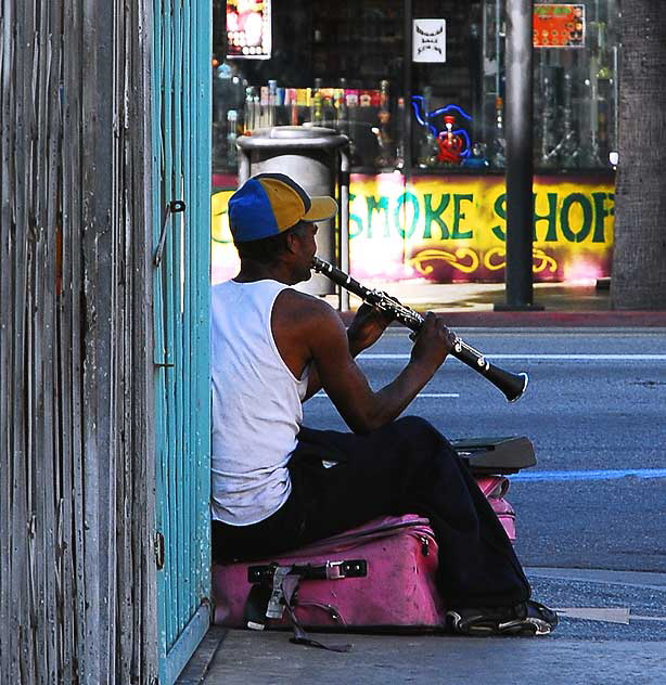 Street musician, clarinet and pink suitcase, Hollywood Boulevard at Cherokee