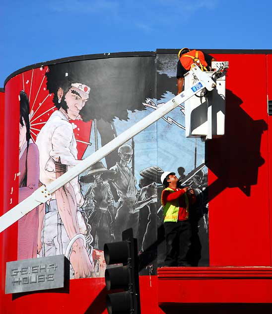 Workers installing new graphic at the Geisha House, Hollywood Boulevard at Cherokee