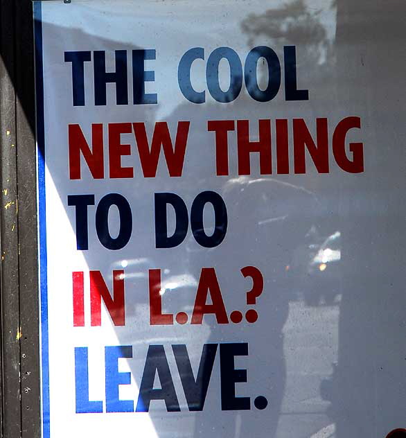 "Leave LA" poster, bus stop, Highland Avenue at Hollywood Boulevard
