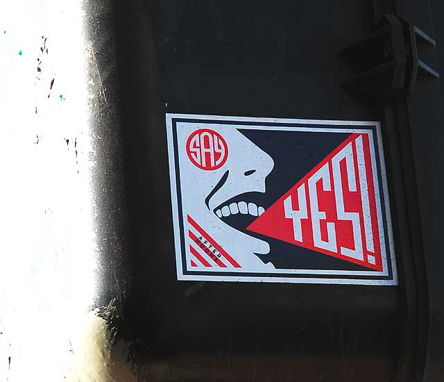 "Say Yes" sticker on traffic signal, 5500 Wilshire Boulevard, Los Angeles