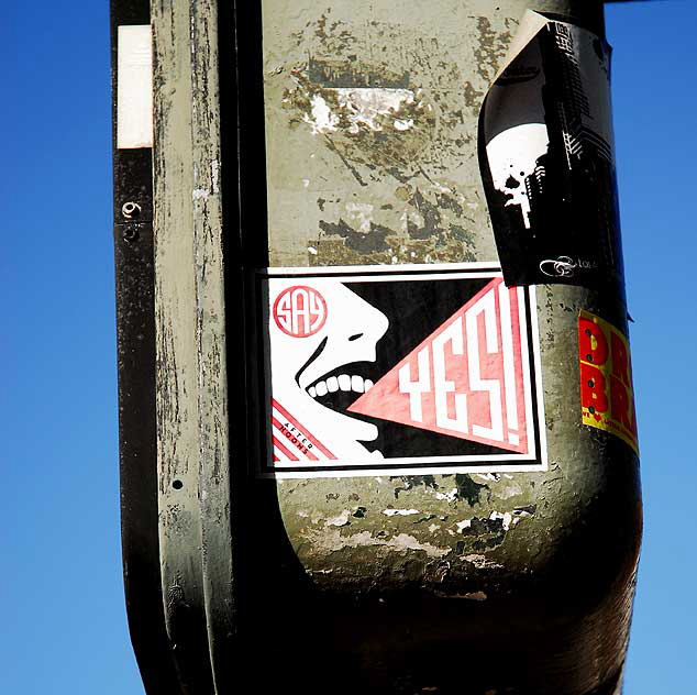 "Say Yes" sticker on traffic signal, 5500 Wilshire Boulevard, Los Angeles