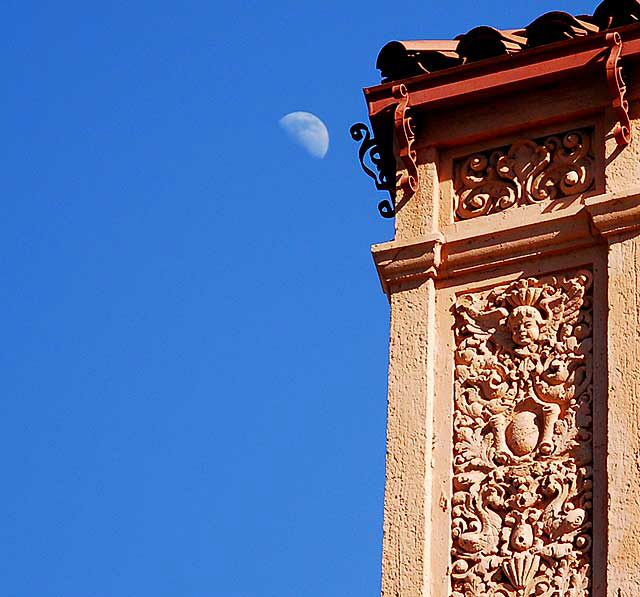 Moon in daytime sky over Colonial Revival apartment building on Wilshire Boulevard, Los Angeles