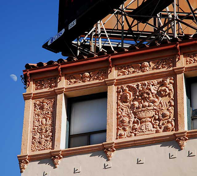 Moon in daytime sky over Colonial Revival apartment building on Wilshire Boulevard, Los Angeles