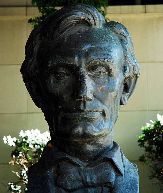 The bust of Lincoln sits quietly in the shade on his two-hundredth birthday, downtown at the Federal courthouse in Los Angeles