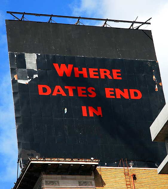 Mysterious black billboard with red letters over Hollywood and Vine