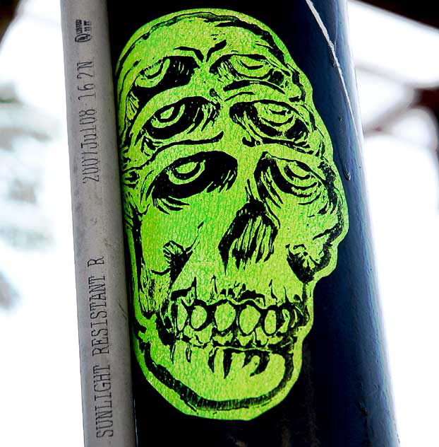 Skull sticker on lamppost, Hollywood 