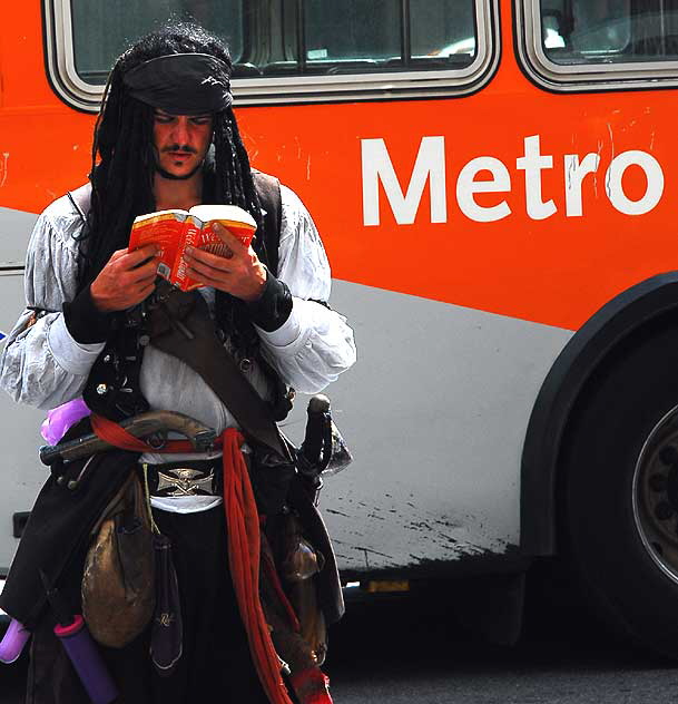 Captain Jack Sparrow reading a book - impersonator on Hollywood Boulevard