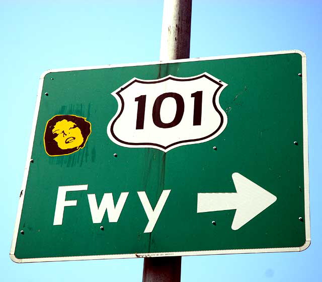 Face sticker on traffic sign, North La Brea at Sunset Boulevard, Hollywood