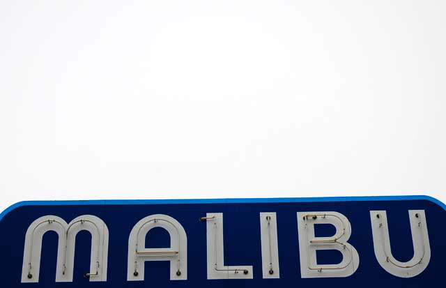 The big blue sign and the base of the Malibu Pier