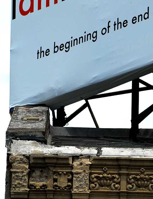 Surreal billboard over crumbling Spanish Colonial Revival building on Hollywood Boulevard