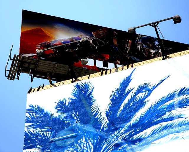 Red billboard above blue palm graphic, Hollywood and Vine  
