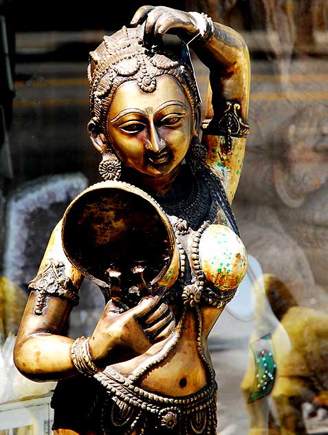 Woman and Mirror, gold Indian figure on display at antique shop on Sunset Boulevard 