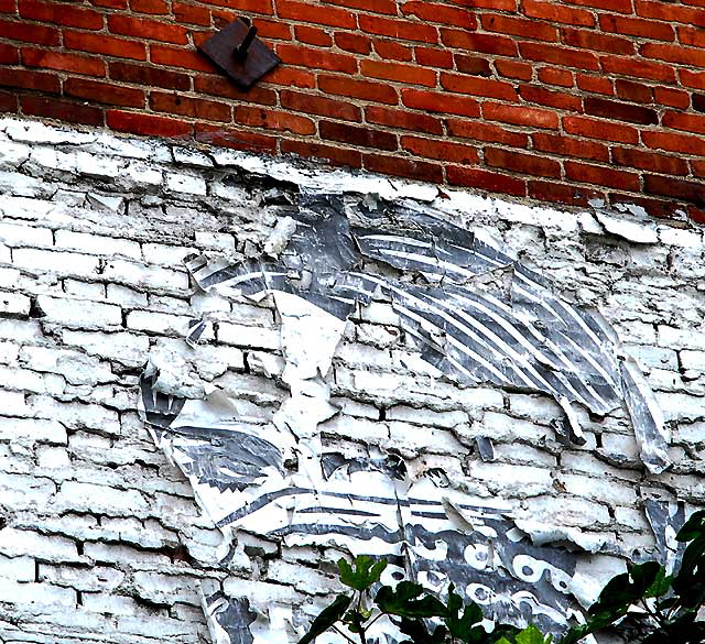 East Hollywood, a masked woman on brick