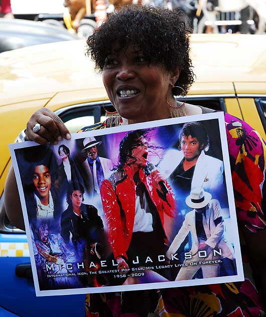 The scene on Hollywood Boulevard on Friday, June 26, 2009 - the day after the death of Michael Jackson - fan with photo