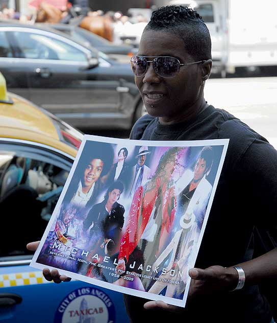 The scene on Hollywood Boulevard on Friday, June 26, 2009 - the day after the death of Michael Jackson - fan with photo