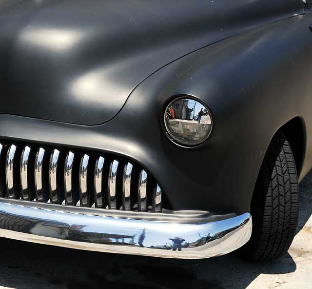 Highly customized flat-black chopped and channeled '51 Mercury parked at a body shop next to a tattoo parlor on Melrose Avenue a few feet east of Cahuenga Boulevard, just south of Hollywood 