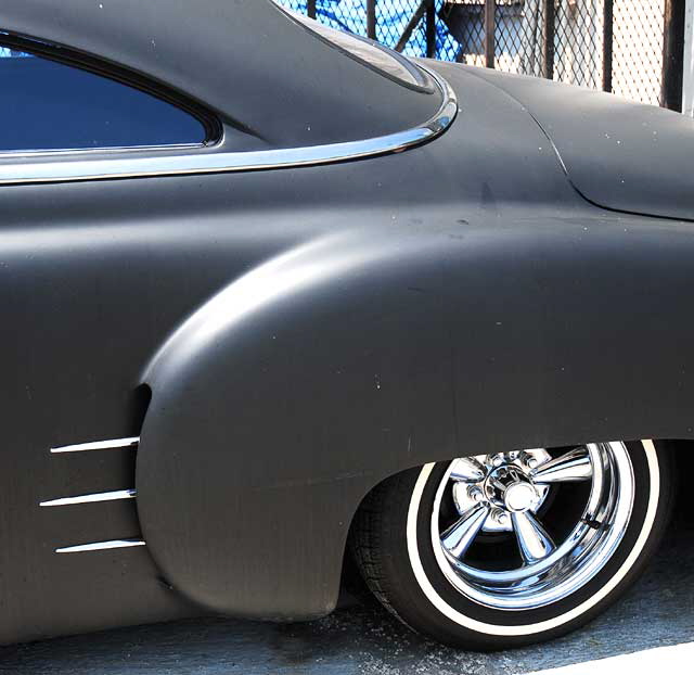 Highly customized flat-black chopped and channeled '51 Mercury parked at a body shop next to a tattoo parlor on Melrose Avenue a few feet east of Cahuenga Boulevard, just south of Hollywood 