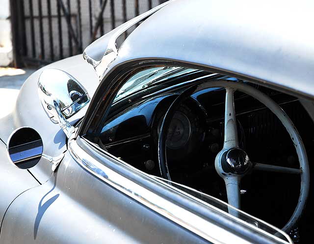 Highly customized flat-black chopped and channeled '51 Mercury parked at a body shop next to a tattoo parlor on Melrose Avenue a few feet east of Cahuenga Boulevard, just south of Hollywood 