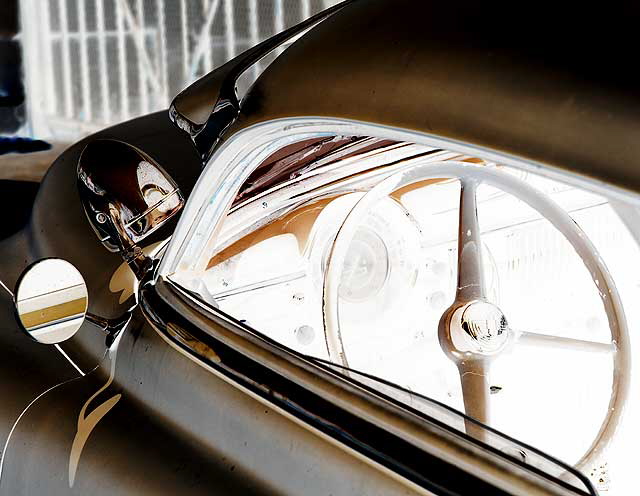 Highly customized flat-black chopped and channeled '51 Mercury parked at a body shop next to a tattoo parlor on Melrose Avenue a few feet east of Cahuenga Boulevard, just south of Hollywood 