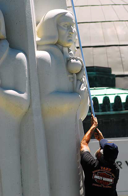 Men at work at the Astronomers Monument at the Griffith Park Observatory high above Hollywood