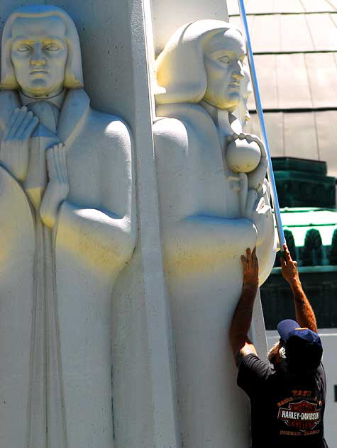 Men at work at the Astronomers Monument at the Griffith Park Observatory high above Hollywood