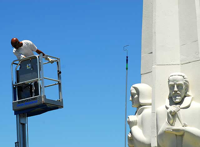 Men at work at the Astronomers Monument at the Griffith Park Observatory high above Hollywood