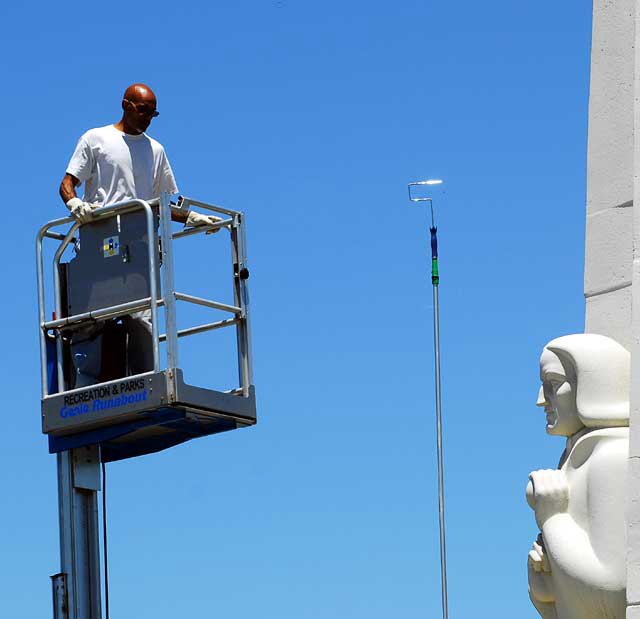 Men at work at the Astronomers Monument at the Griffith Park Observatory high above Hollywood