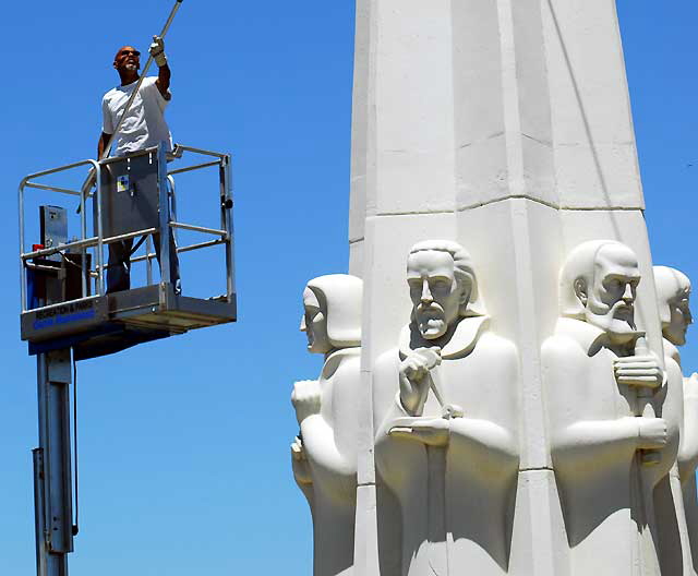 Men at work at the Astronomers Monument at the Griffith Park Observatory high above Hollywood
