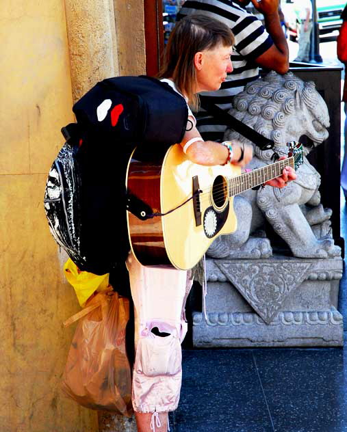 Homeless musician with guitar at the Pig and Whistle, Hollywood Boulevard