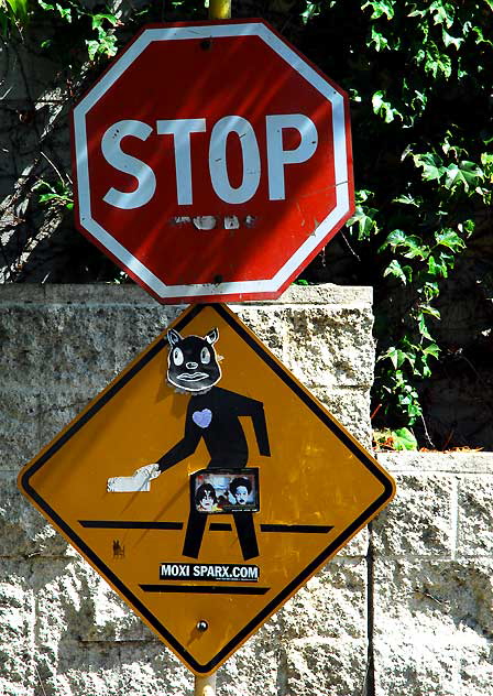Cat sticker on Pedestrian Crossing sign at the post office on Cherokee in Hollywood