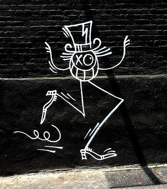 Stick figure on black brick wall, parking lot of Hollywood Boulevard in Los Feliz 