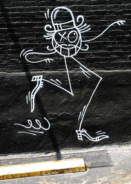 Stick figure on black brick wall, parking lot of Hollywood Boulevard in Los Feliz 