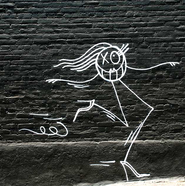 Stick figure on black brick wall, parking lot of Hollywood Boulevard in Los Feliz 