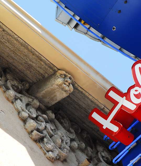 Above the Snow White Bar and Grill on Hollywood Boulevard, next to the Hollywood Wax Museum, faces in the eaves