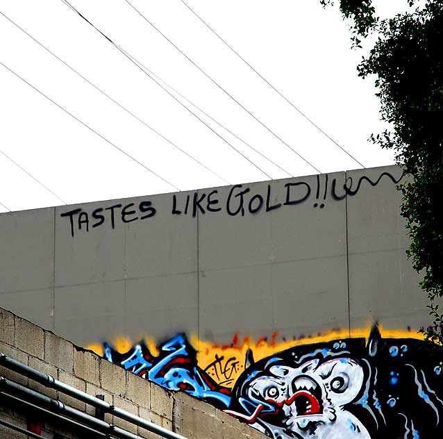 "Tastes like Gold" graffiti on blank billboard, Santa Monica Boulevard