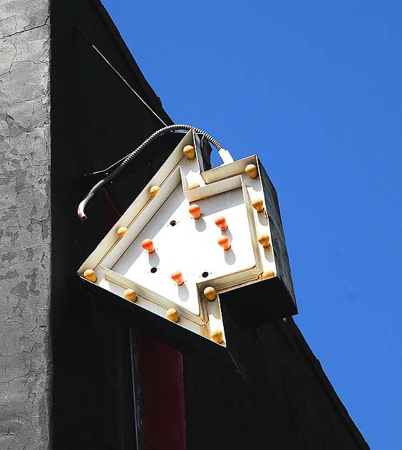 White arrow, black wall, blue sky - Melrose Avenue