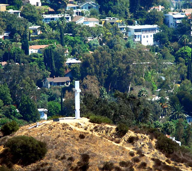 The view from high up on Mulholland Drive, above Hollywood  ambient temperature, 97 Fahrenheit, humidity near zero, light Santa Ana winds blowing the grit in off the Mojave, and the smoke from all the fires  so dust, smoke, photochemical smog, all trapped by an inversion layer