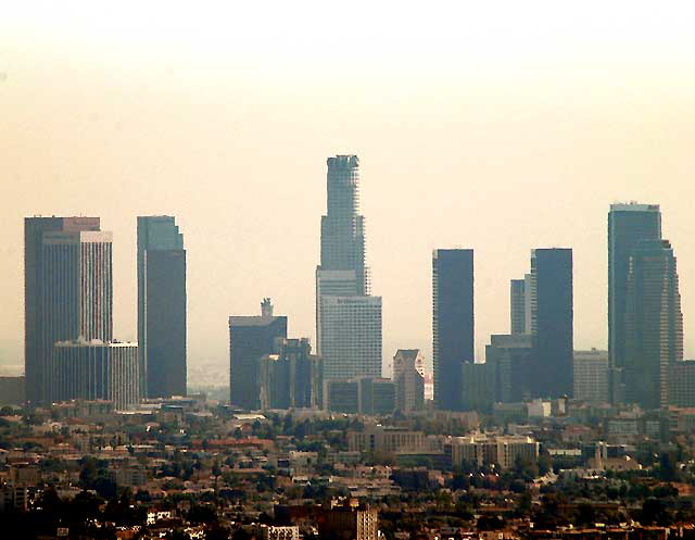 The view from high up on Mulholland Drive, above Hollywood  ambient temperature, 97 Fahrenheit, humidity near zero, light Santa Ana winds blowing the grit in off the Mojave, and the smoke from all the fires  so dust, smoke, photochemical smog, all trapped by an inversion layer