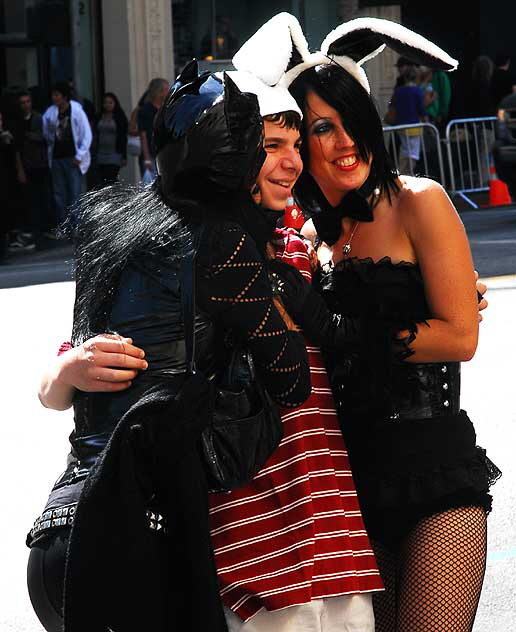 Tourist with Catwoman and Playboy Bunny impersonators - Hollywood Boulevard