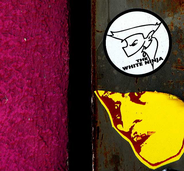 White Ninja sticker, yellow face, purple wall